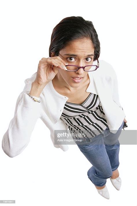 A Woman In Fishnet Top And Glasses Posing For The Camera A Woman In Fishnet Top And Glasses Posing For The Camera